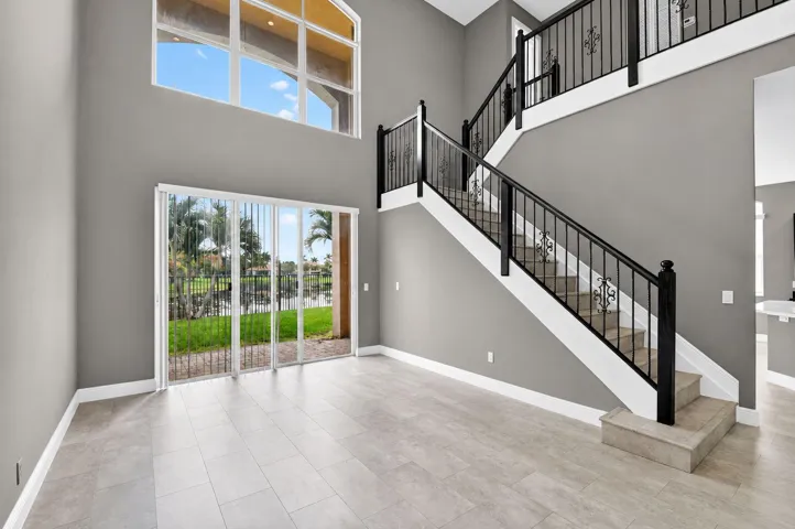 Enter through foyer into living room with double height ceiling and tons of natural light