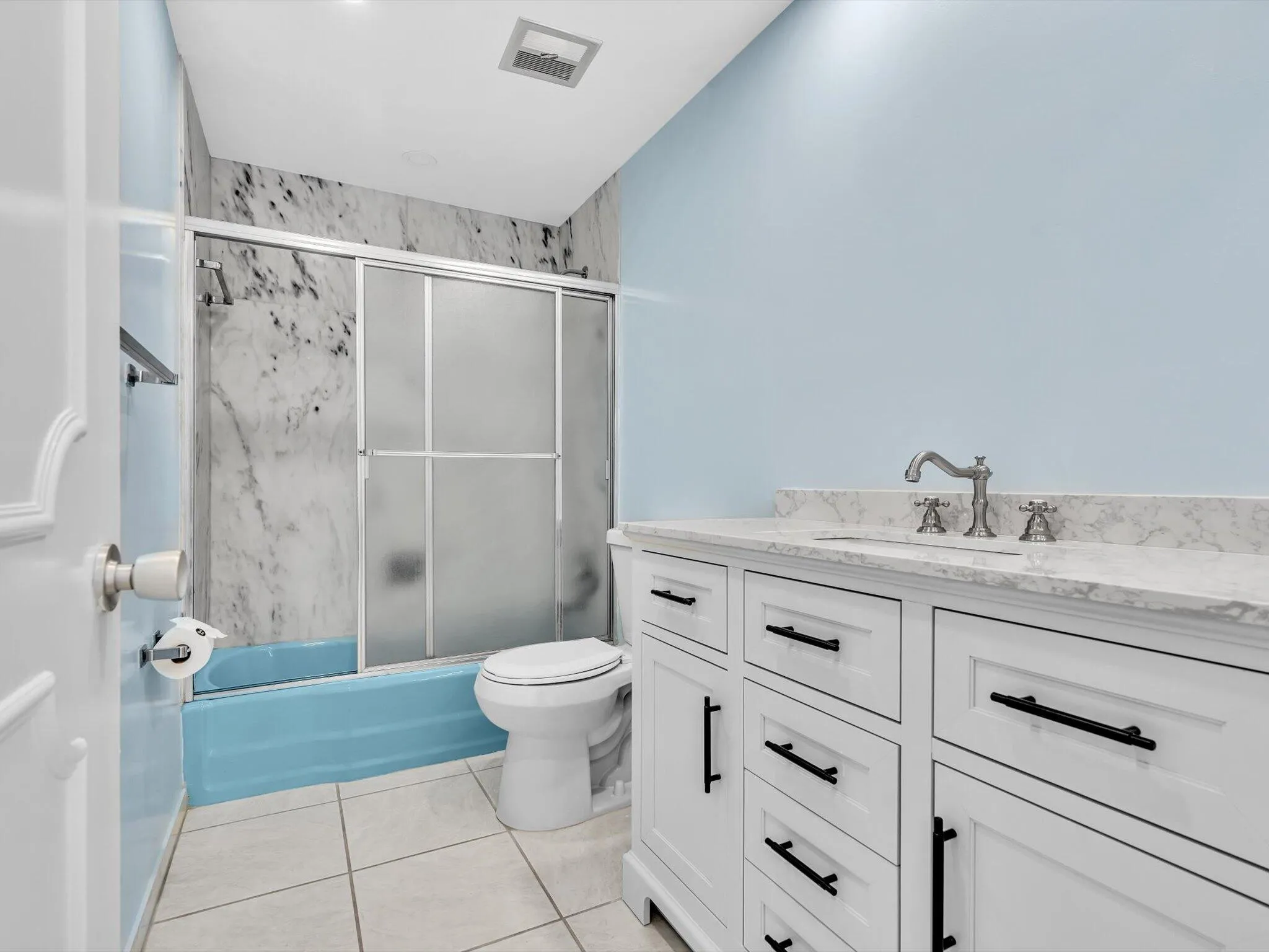 Hall bathroom features tub with shower
