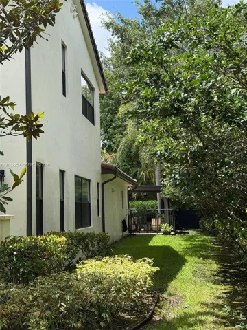 RIGHT SIDE OF HOME, LEADING TO POOL DECK.