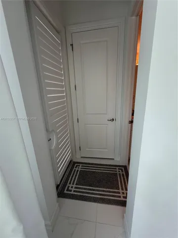 DOOR LEADING TO POOL DECK AND ACCESS TO CABANA BATH
