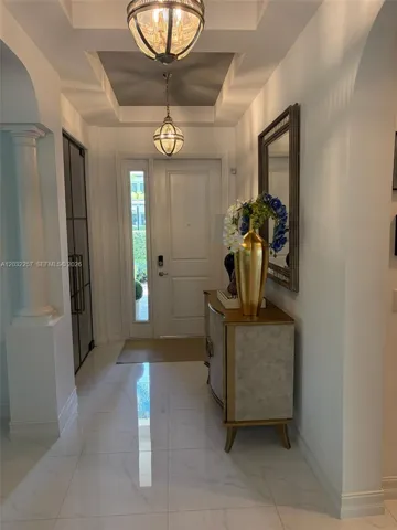 FOYER, CUSTOM MADE GLASS DOORS ON THE LEFT LEADING TO WINE CELLAR.