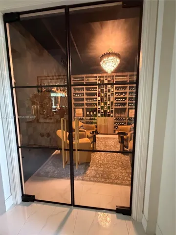 CUSTOM GLASS DOORS LEADING TO WINE CELLAR