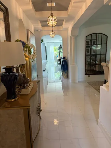 FOYER, WITH DIRECT VIEWS TO THE GARDEN. ARCHED ENTRYWAYS THROUGHOUT, PORCELAIN 24 X 24 TILES ENTIRE FIRST FLOOR