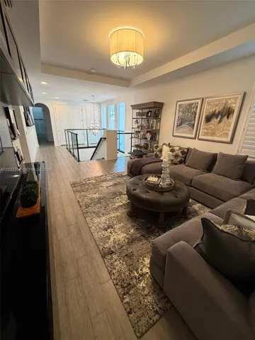 LOFT HAS A TRAY CEILING ADORNED WITH A FLUSHED PENDANT. ARCHED WALK WAYS LEADING TO THE OTHER 4 BEDROOMS AND 2 BATHS.