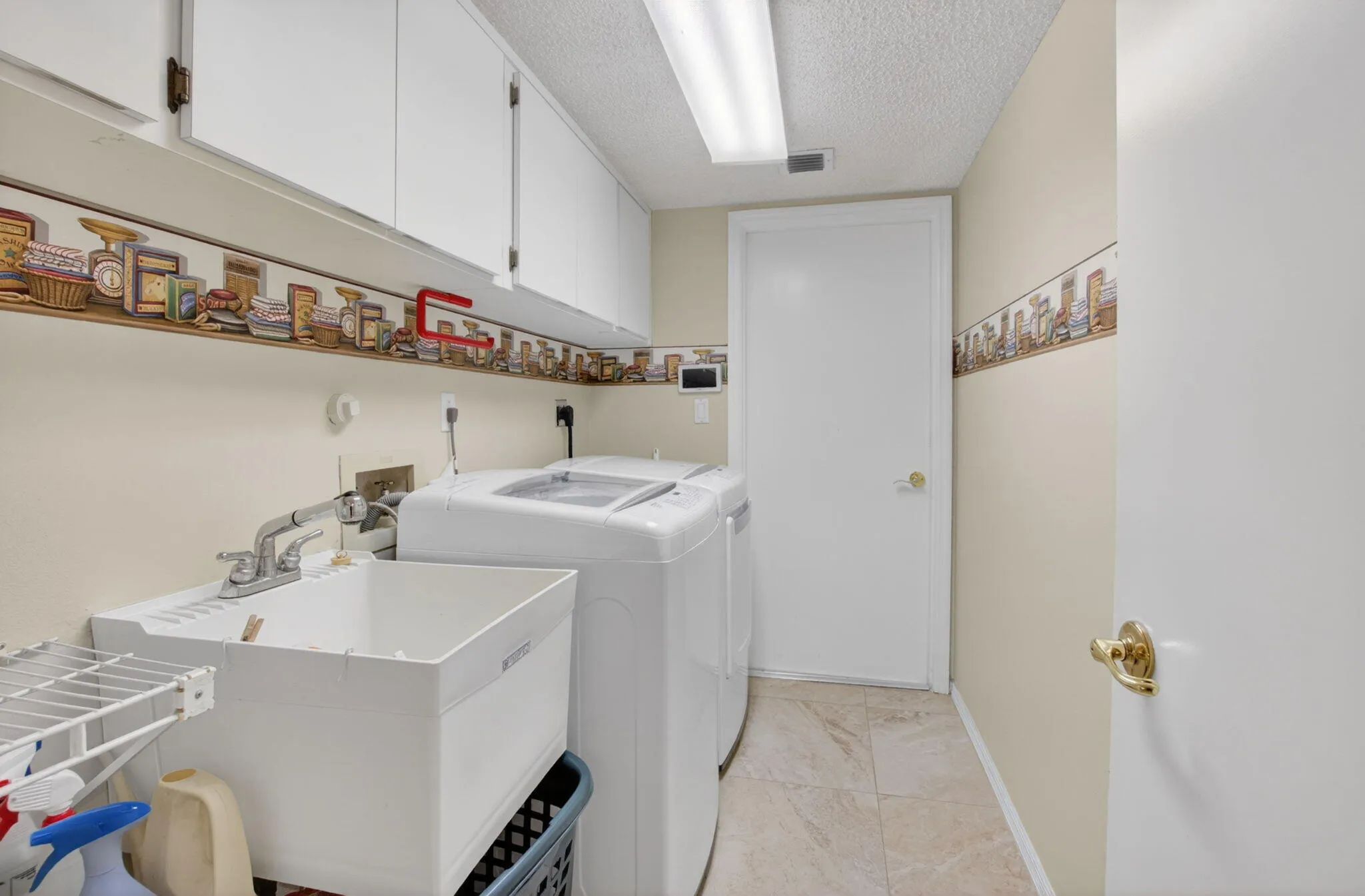 Laundry Room with upper cabinets and sink
