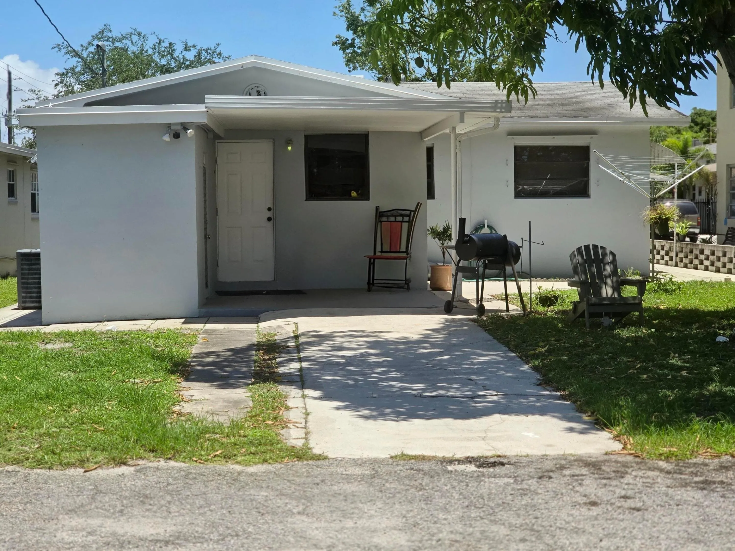 BACK YARD - COVERED PORCH AREA AND ENTRY TO LAUNDRY ROOM AND RENTAL STUDIO/EFFICIENCY