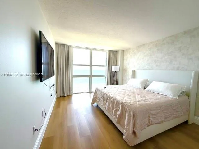 Primary Bedroom with floor to ceiling views of the ocean