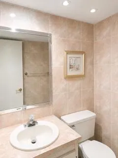 Floor to ceiling immaculate tile with custom recessed lighting and finished ceiling.