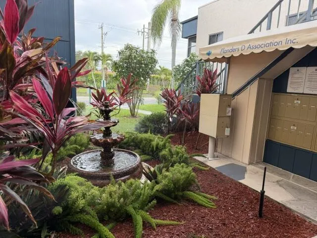 Decorative water wishing well adjacent to mailbox location.