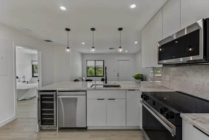 Kitchen with upgraded stainless steel Samsung appliances. Noce wine fridge.