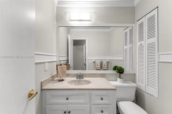 Half bathroom with storage closet.