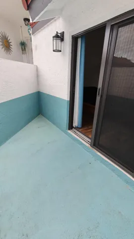 Enclosed patio adjacent to primary bedroom