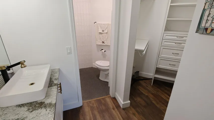 Primary bedroom bathroom and walk-in closet