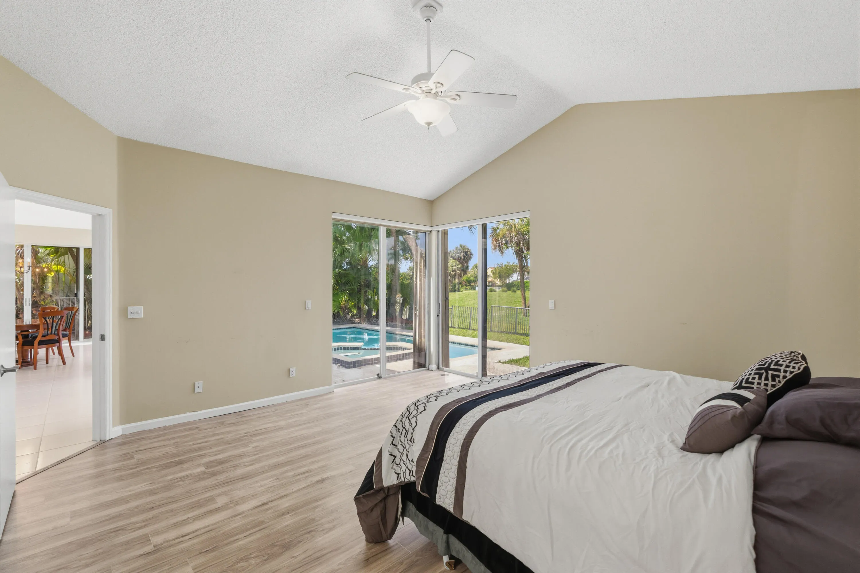 Huge Primary Bedroom overlooking the pool with views toward the golf course.