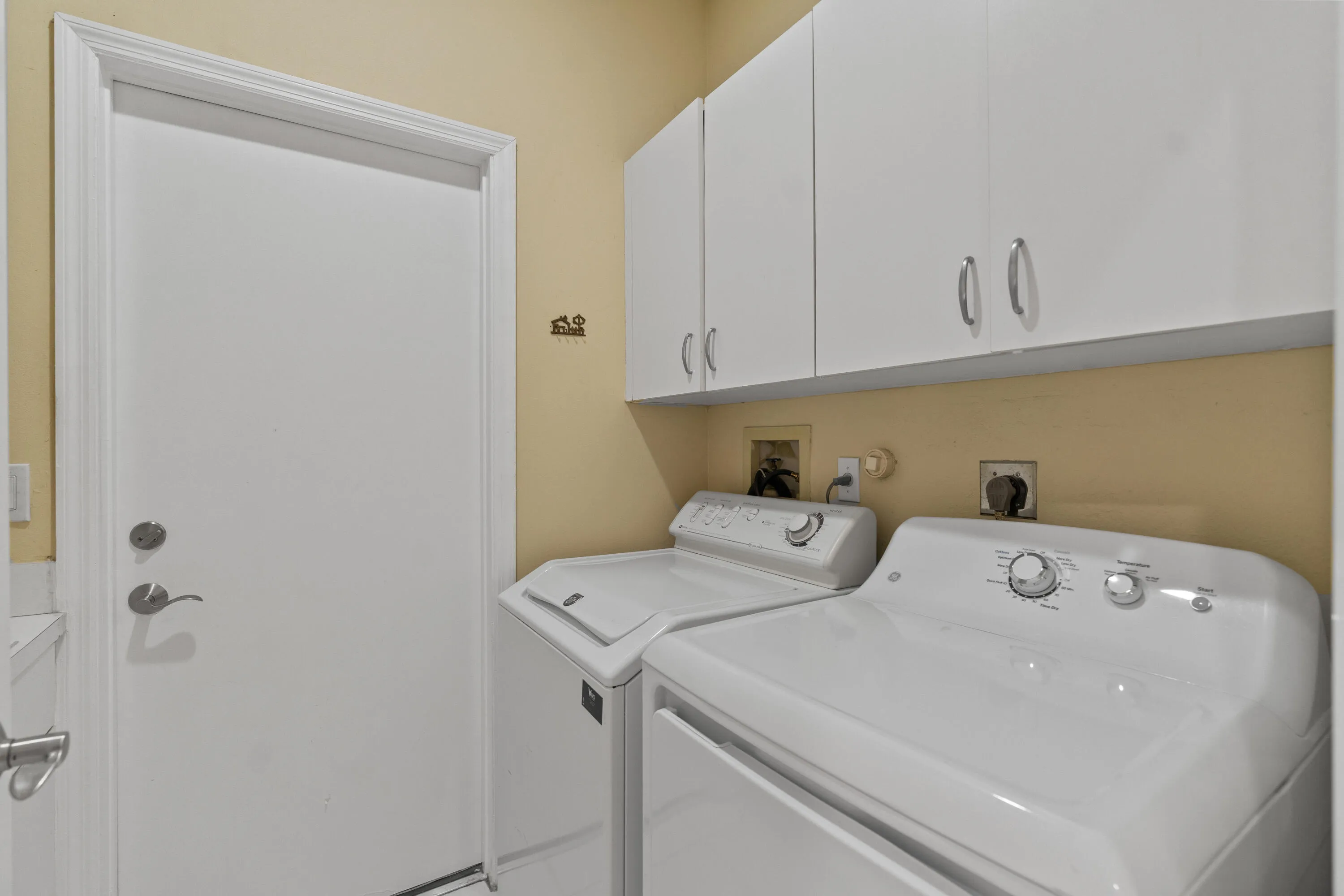 Interior laundry room also has a utility sink on the opposite wall.