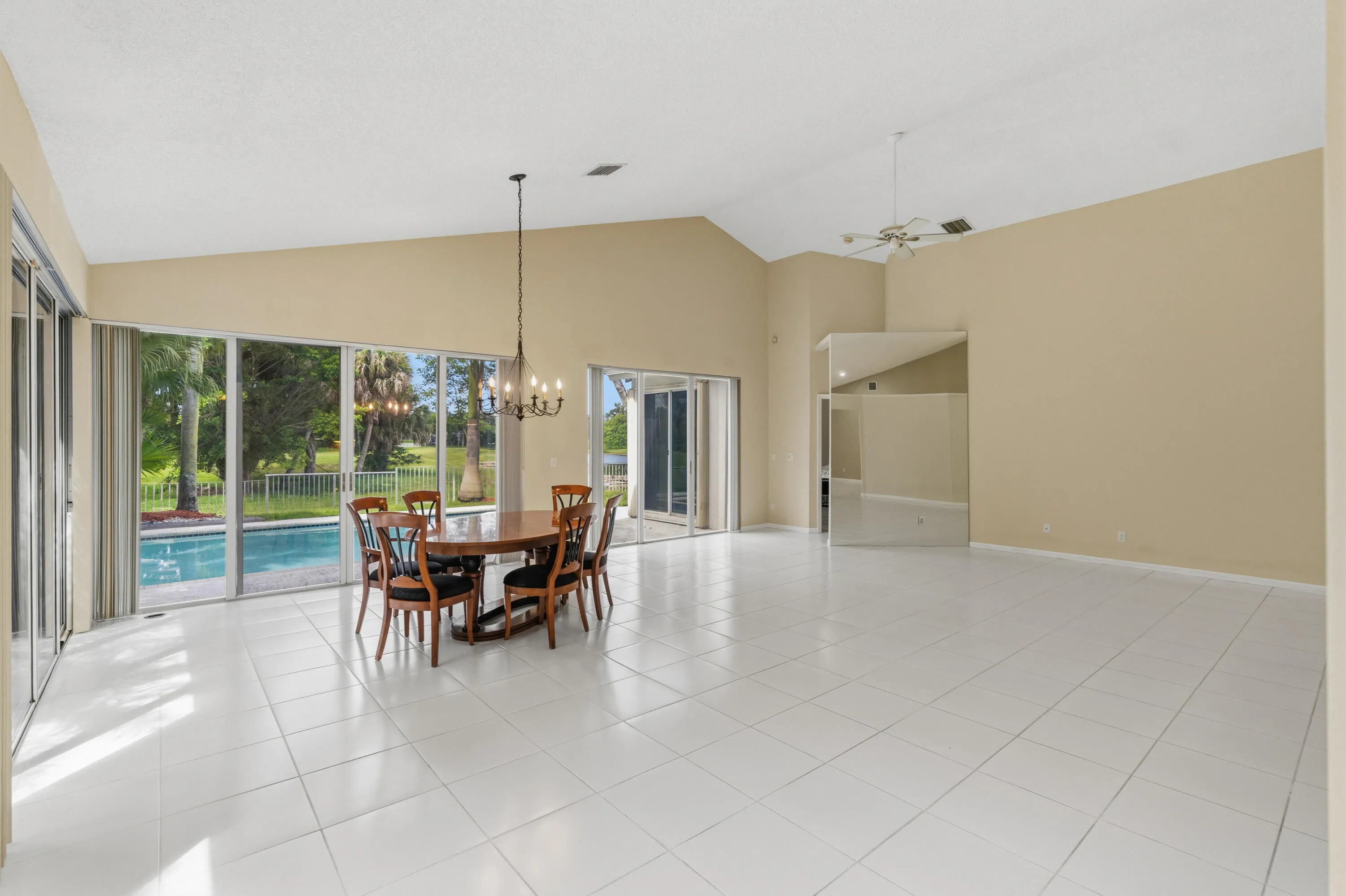 Great room with soaring ceilings and views of the pool and golf course.