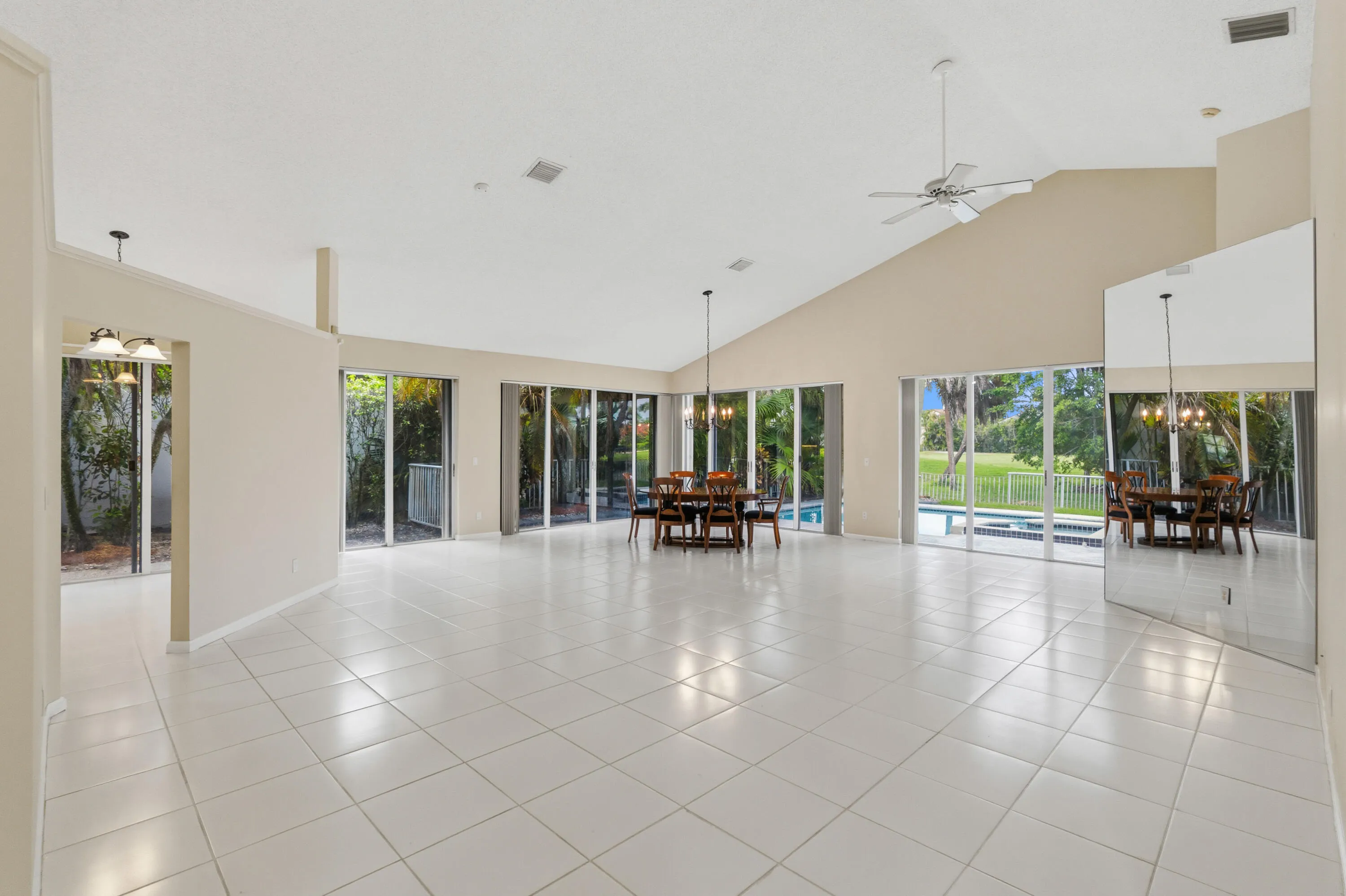 Great room with soaring ceilings and views of the pool and golf course.