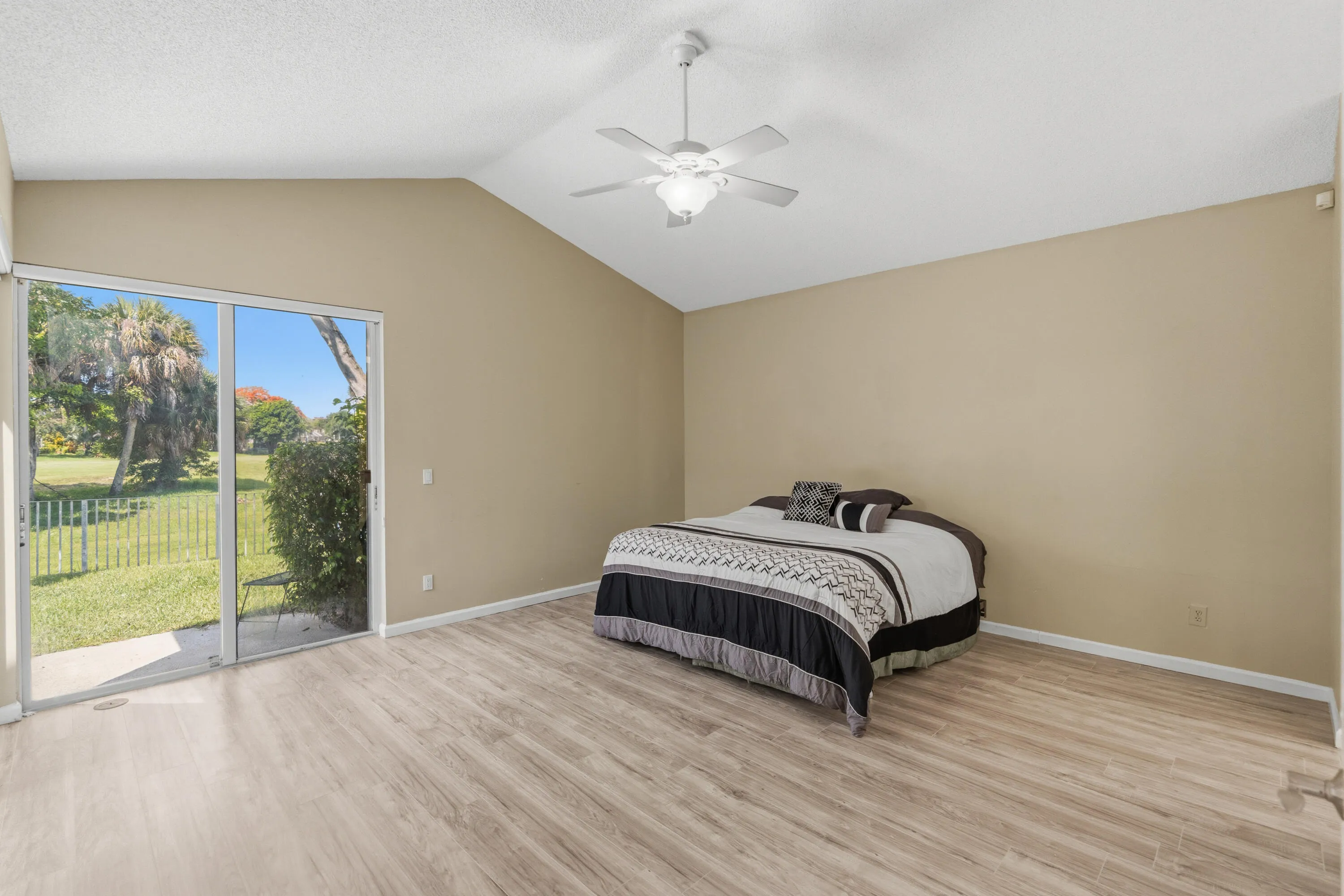 Huge Primary Bedroom overlooking the pool with views toward the golf course.