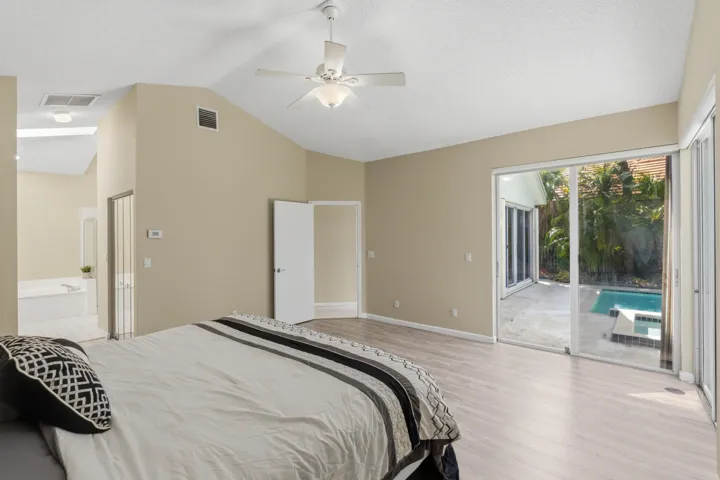 Huge Primary Bedroom overlooking the pool with views toward the golf course.