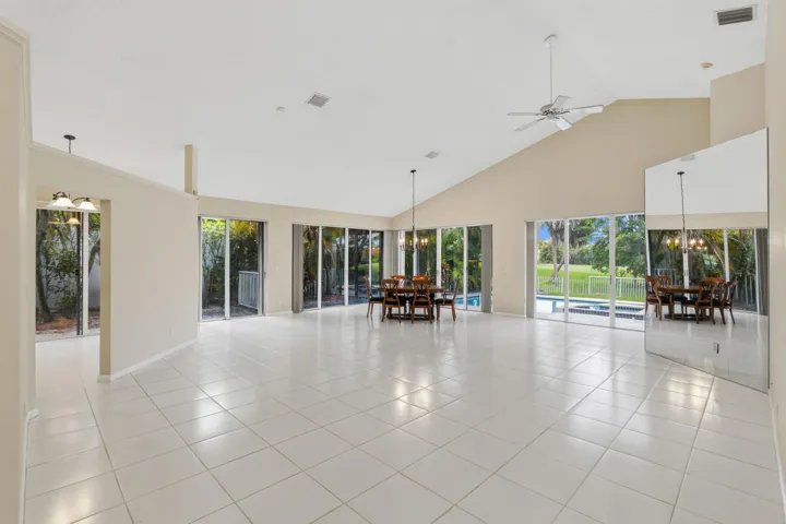 Great room with soaring ceilings and views of the pool and golf course.