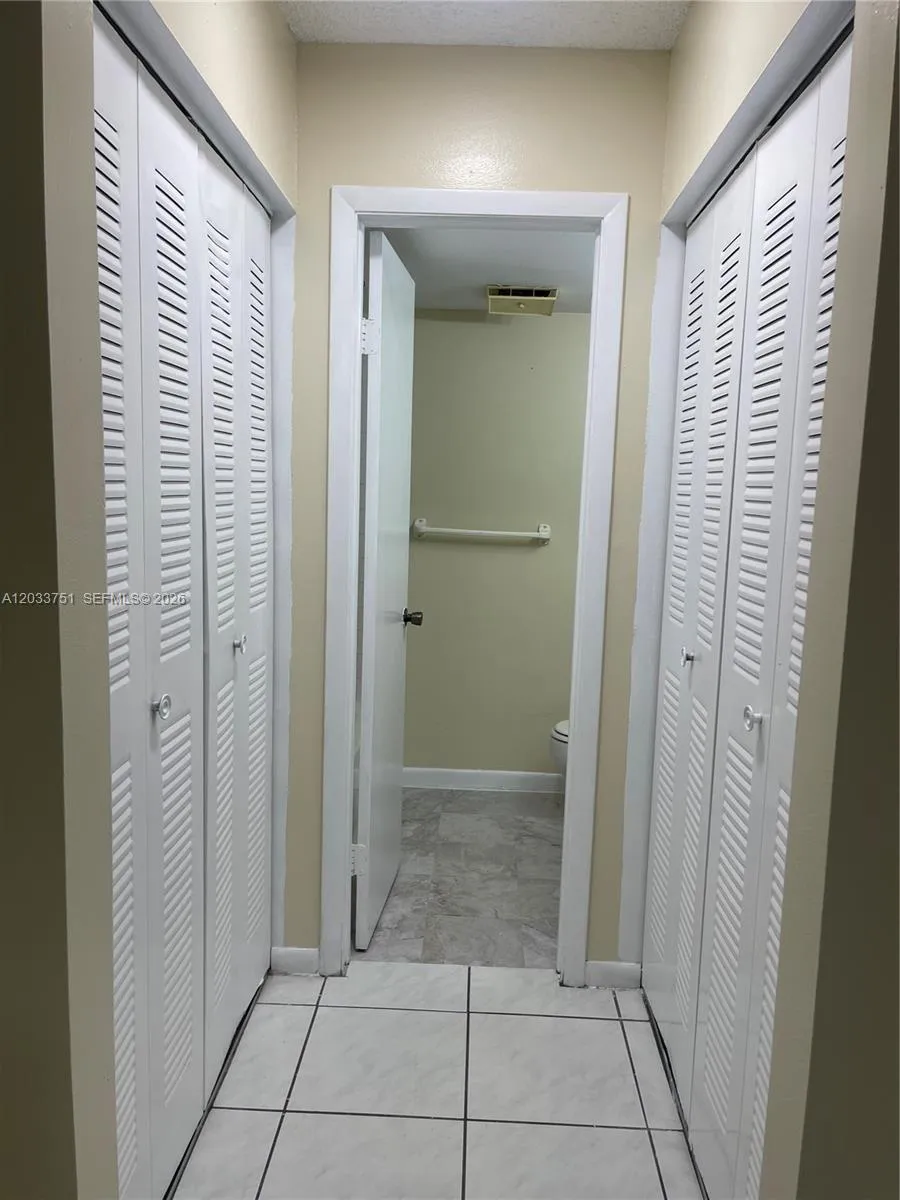Closets and hallway to bathroom