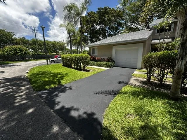 One car garage with a driveway to accommodate 2 cars