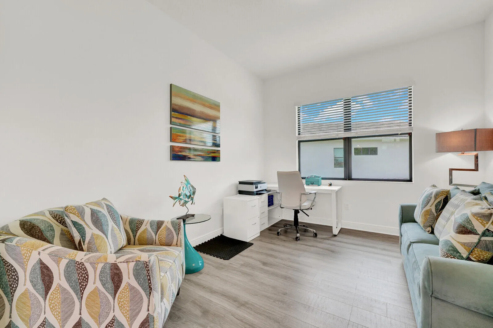 Neutral white walls complement light wood-finish flooring