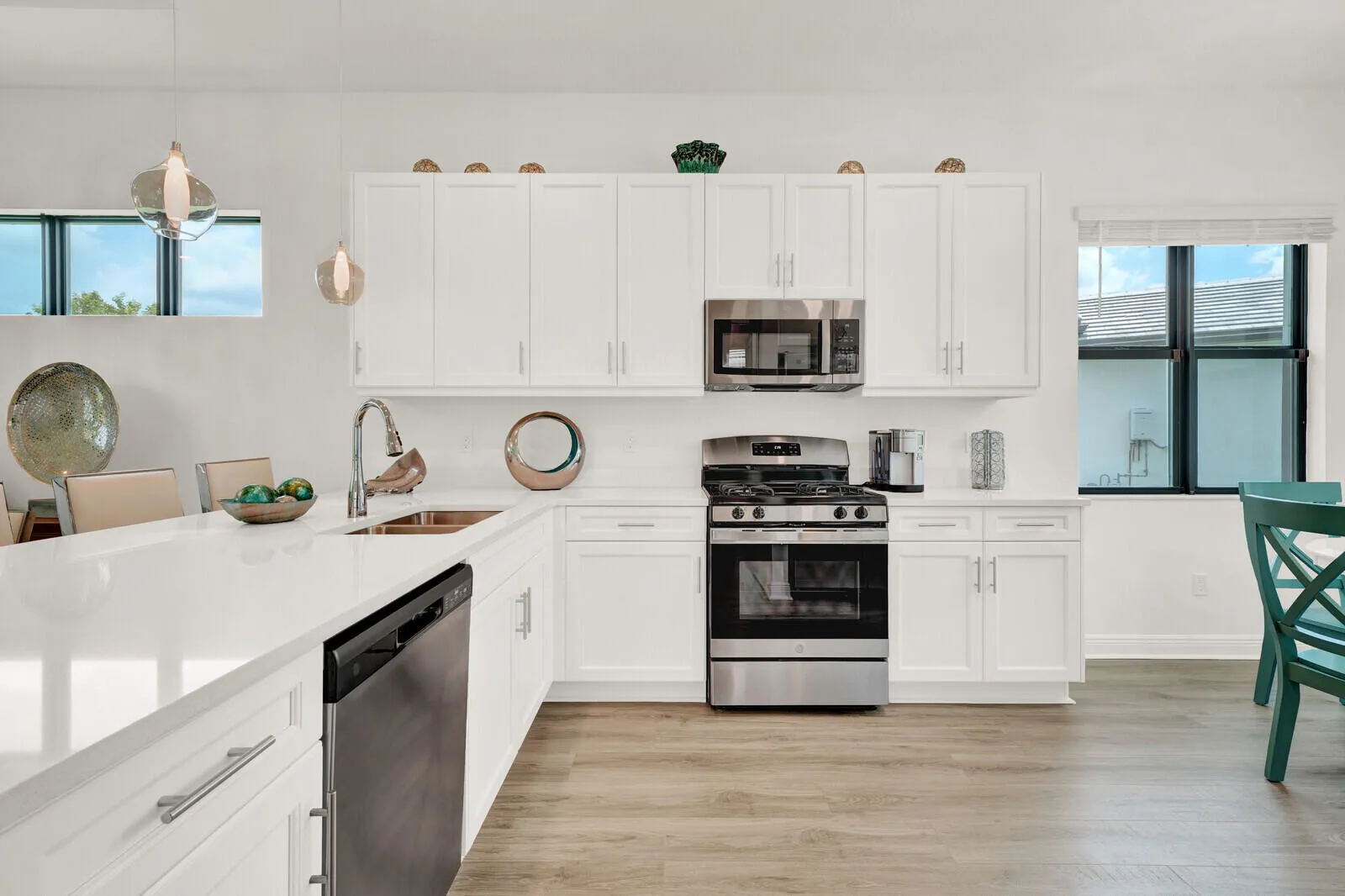 Modern kitchen with white cabinetry and light-toned countertops