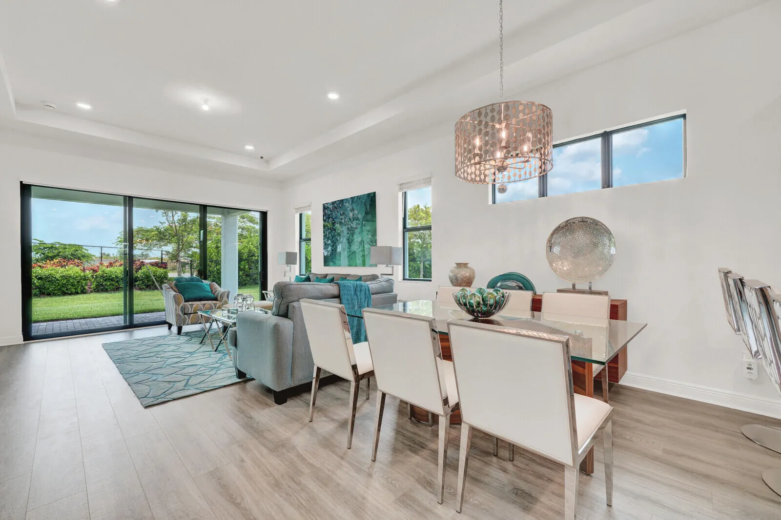 Open concept living and dining area with wood-finish flooring