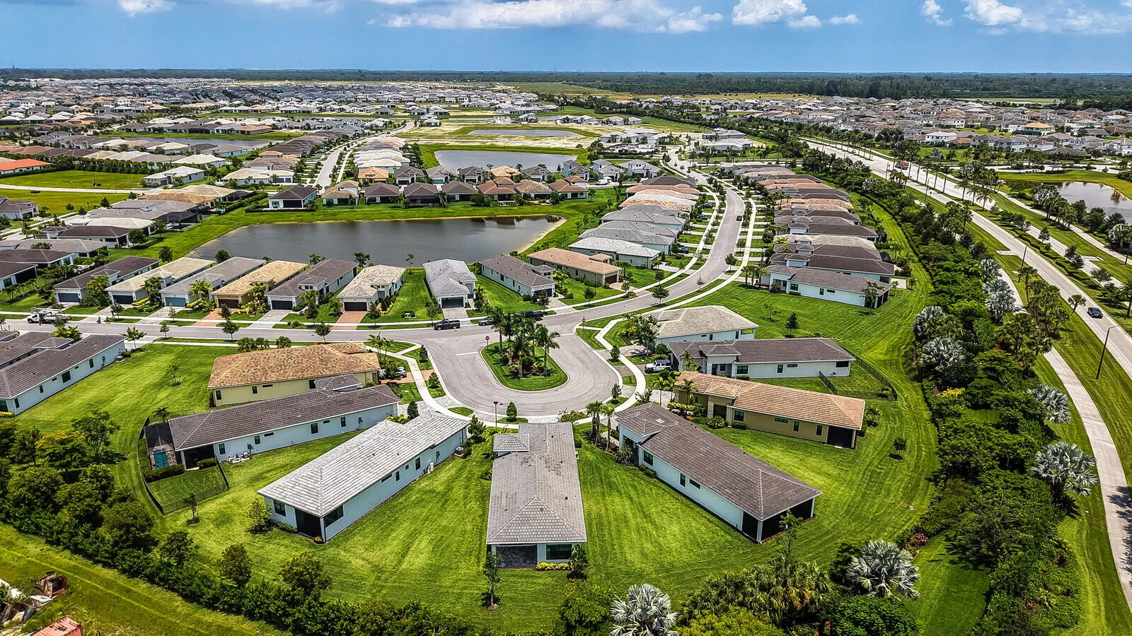 Residential community featuring a curved street design with individual properties set on green lawns