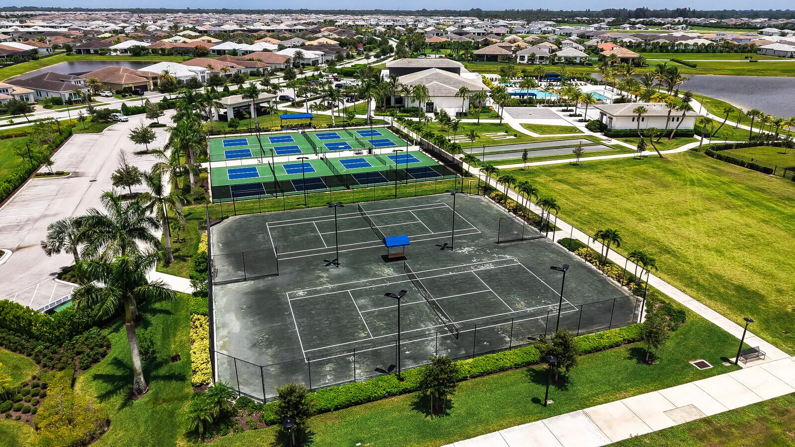 Community recreation area featuring multiple tennis courts and pickleball courts