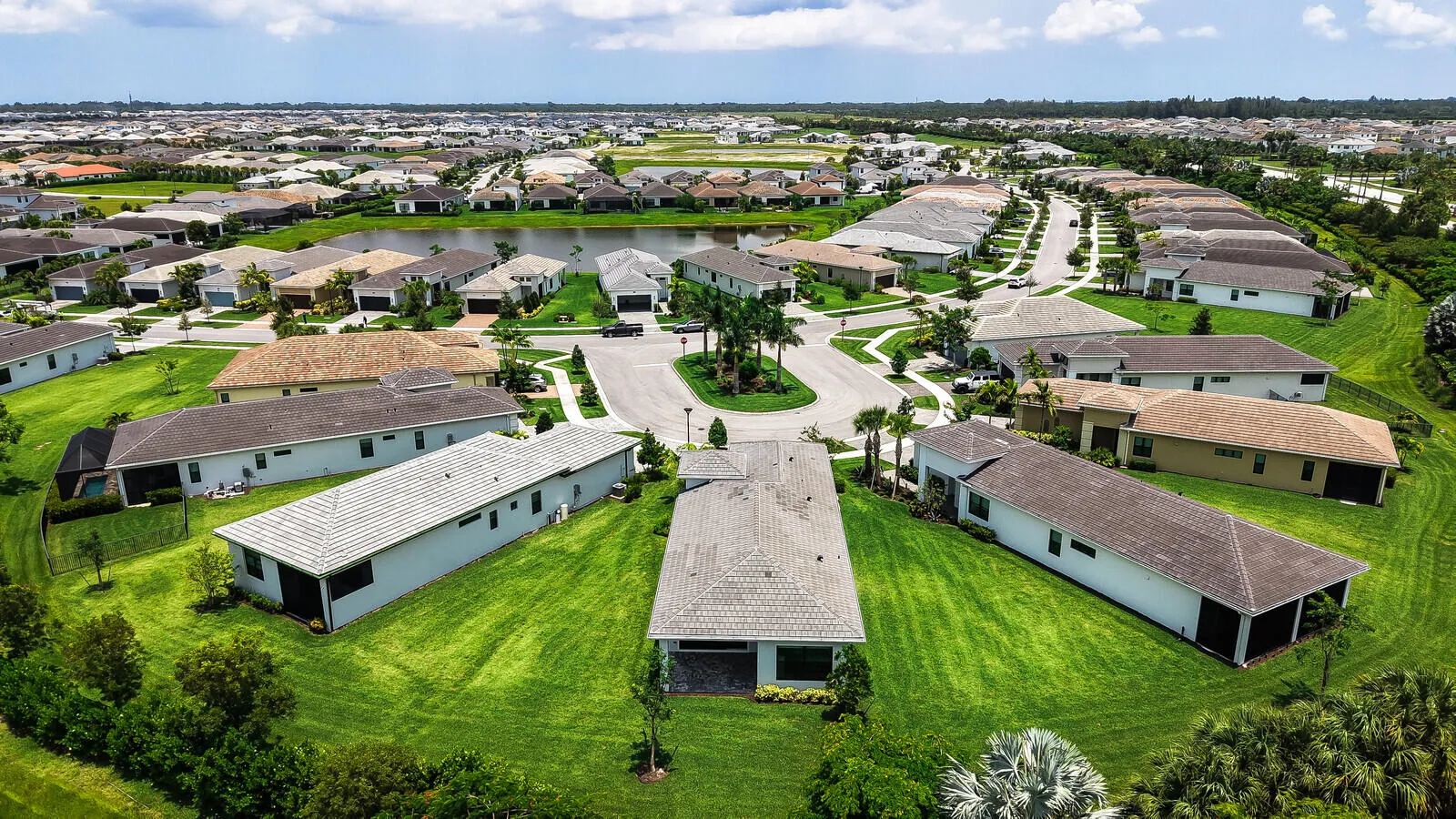 Expansive aerial view of a residential community featuring a central cul-de-sac