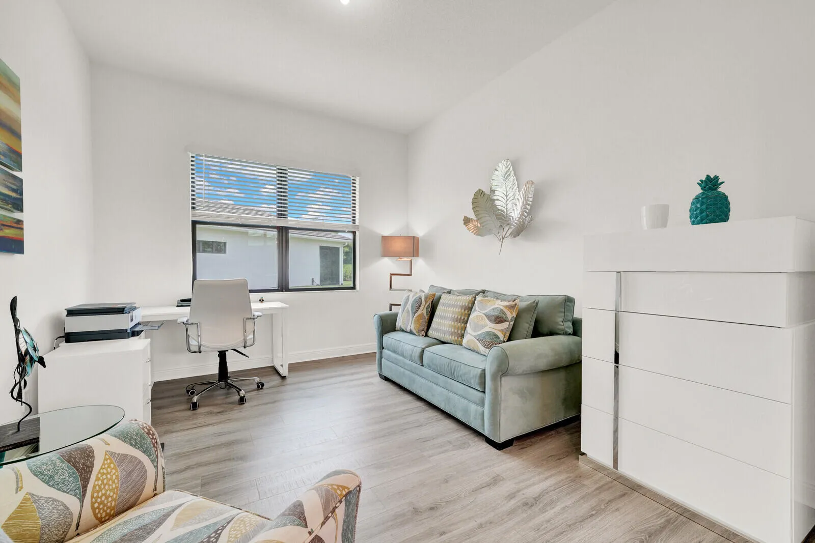 Interior space featuring wood-finish flooring, a large window with blinds, and recessed lighting