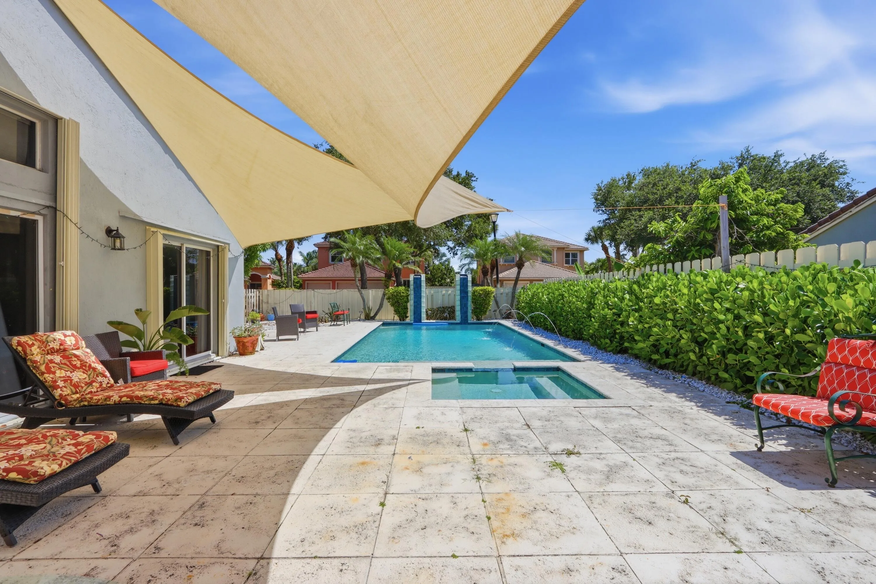 fully fenced back yard with large pool and spa