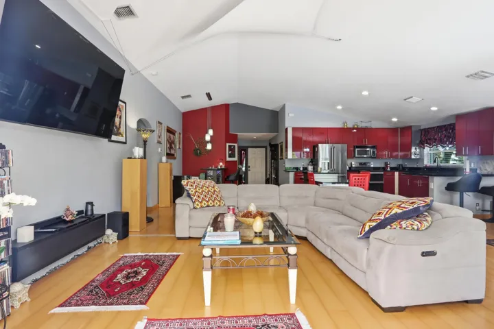 large screen TV wall mounted with wood floors.