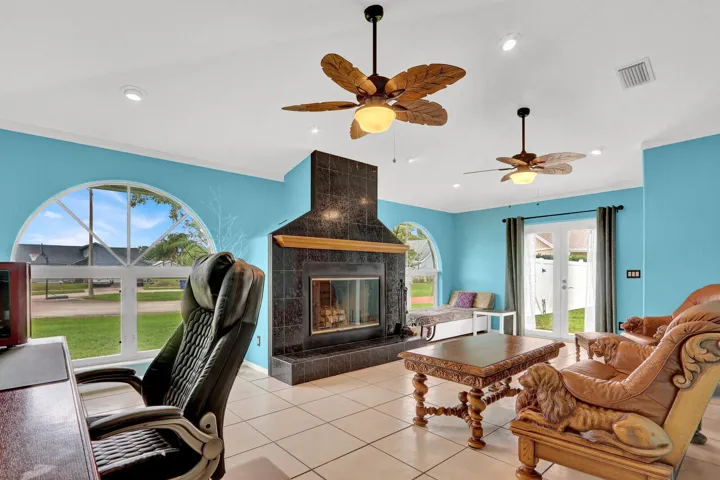 SECOND LIVING ROOM WITH VAULTED CEILINGS AND WOOD BURNING FIREPLACE