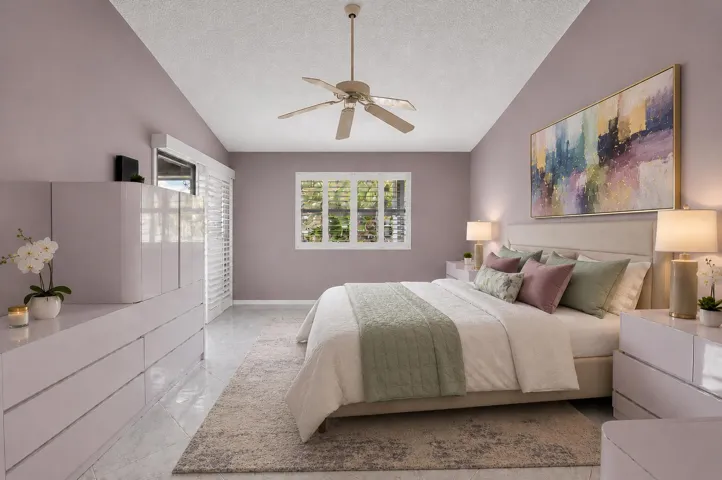 STAGED PRIMARY BEDROOM THAT OPENS TO ENCLOSED BALCONY