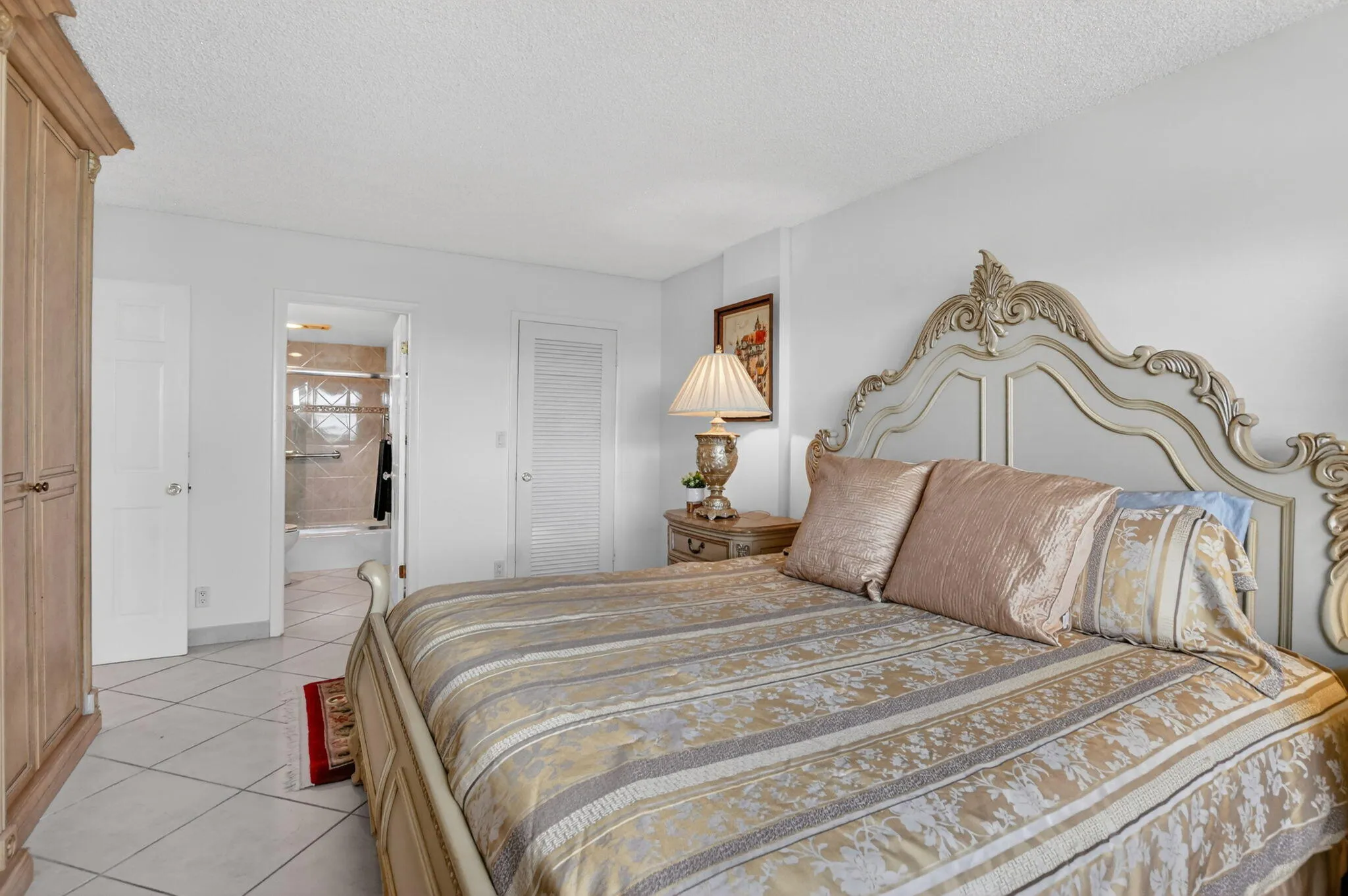 PRIMARY BEDROOM WITH BUILT-IN WALL UNIT FOR AMPLE STORAGE