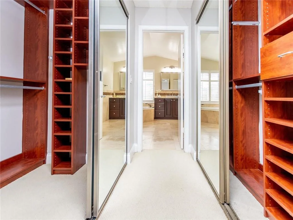 Custom closets of solid hardwood in master suite.