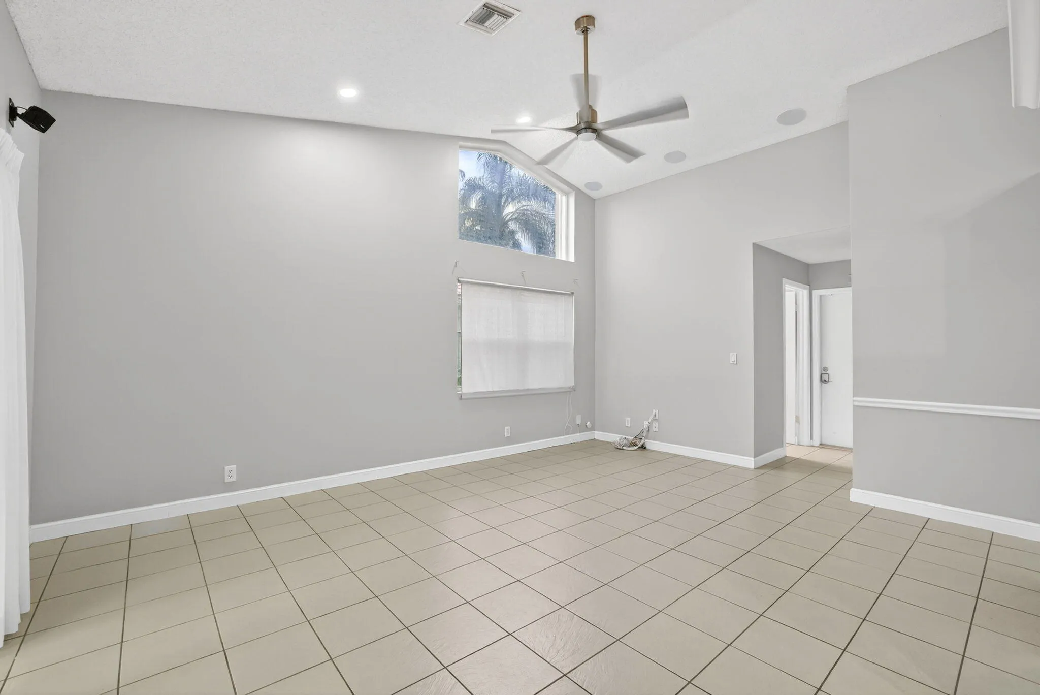 Family Room leads to generous covered patio with built-in serving area, pool & lakeviews!