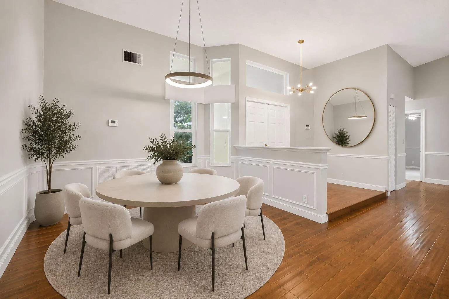 Virtually staged formal dining room and foyer. New modern light fixture.
