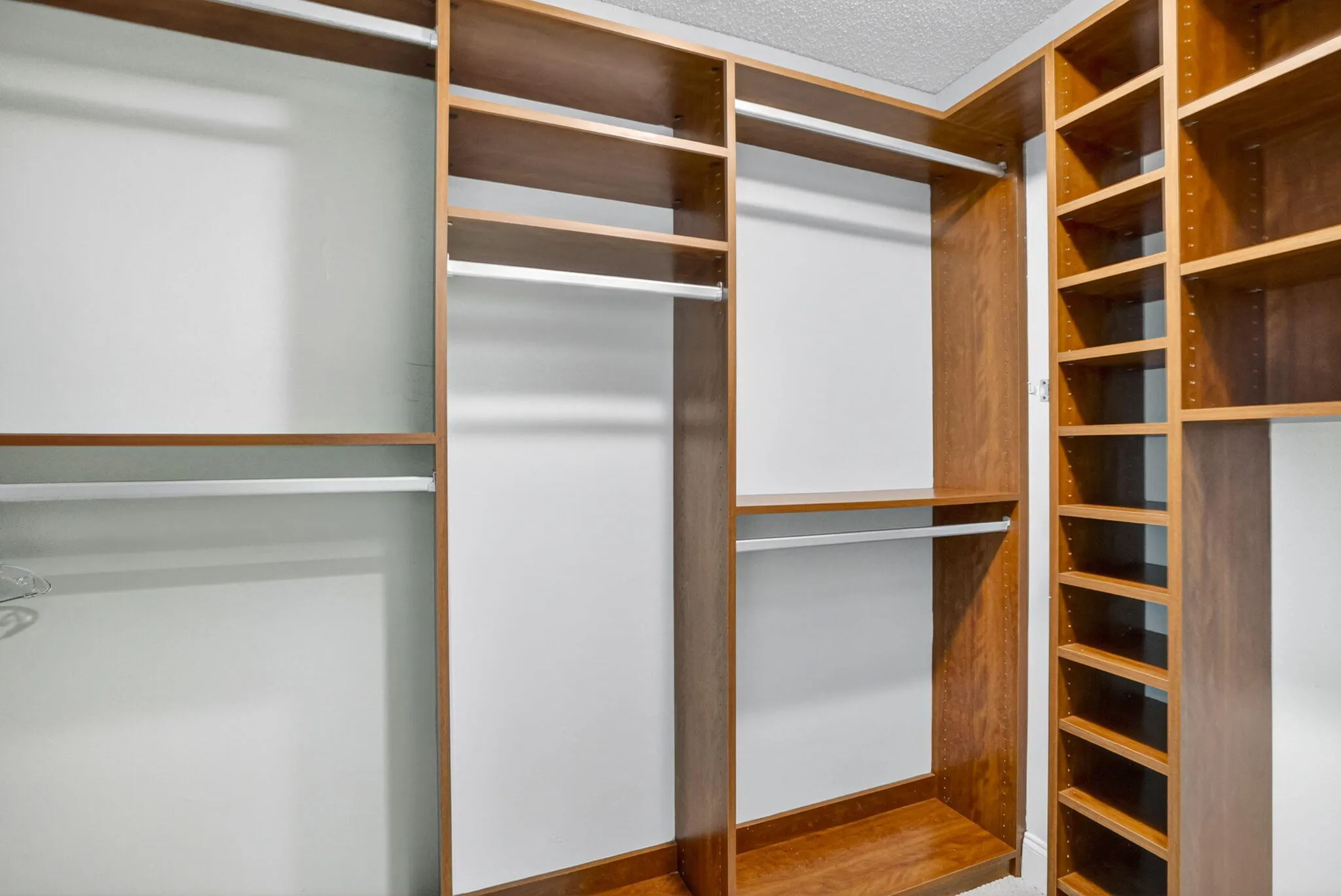 Walk-in custom closets in solid hardwood in primary bedrooms