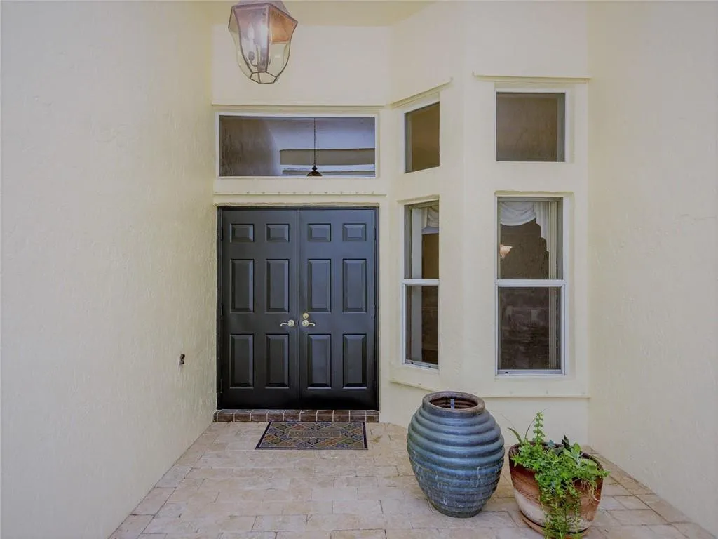 Double door covered entry with saturnia paver flooring.