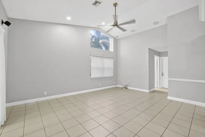 Family Room leads to generous covered patio with built-in serving area, pool & lakeviews!