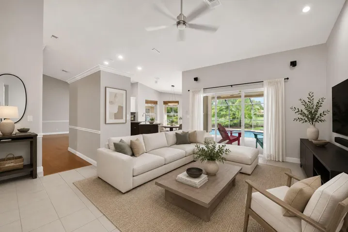 Virtually staged family room with sliding glass doors that lead to second covered patio with outdoor granite serving station with sink.