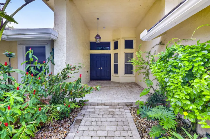 Travertine covered entry to home with double door entry.