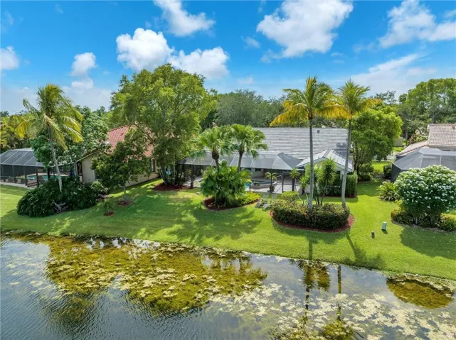 Nestled on a pictureque culdesac tree-lined street, this beautifully maintained single story home sits on a serene peaceful lakefront lot in boutique Weston enclave, Sunset Springs.