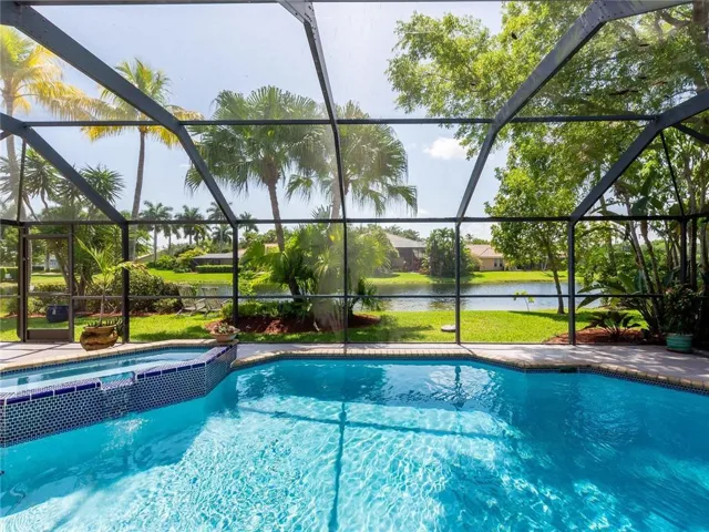 Gorgeous single story home with pool, spa on picturesque lakefront lot in guard gated Weston community!