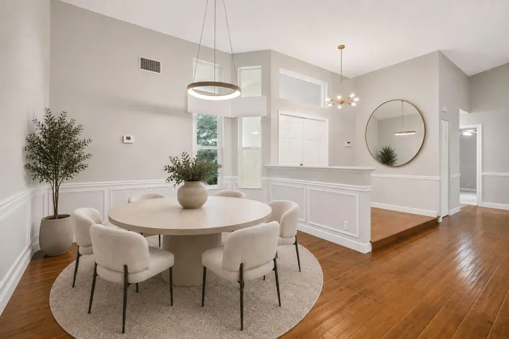 Virtually staged formal dining room and foyer. New modern light fixture.