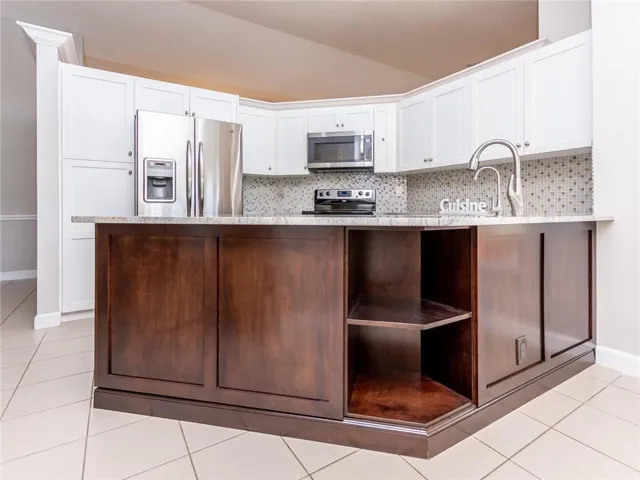 Beautiful remodeled kitchen with dual tone cabs, custsom pullouts, stainless appliances.
